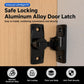 Black rotating door latch lock with mounting plates, installed on door