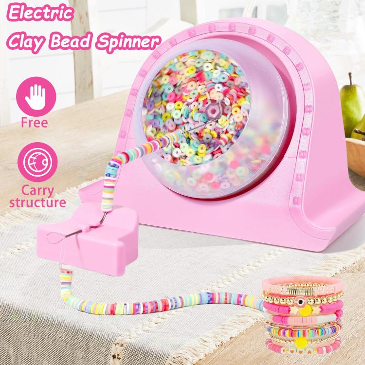 Pink electric clay bead spinner on table with beading needle and stacked colorful bracelets
