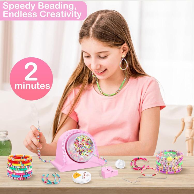 Pink electric clay bead spinner on craft table with young maker threading beads