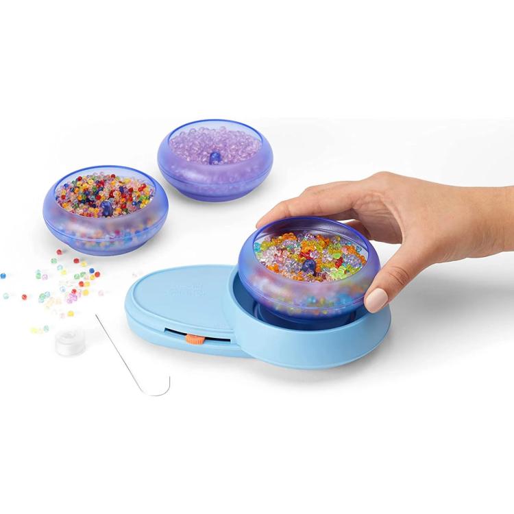 Electric bead spinner with blue base and clear lid filled with multicolor beads