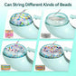 Mint-green bead spinner with colorful beads in bowl and bead strings being threaded