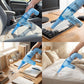 Handheld blue dust cleaner in use on a keyboard and desk clutter