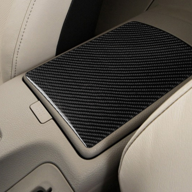 Installed carbon fiber central console storage box cover with textured black surface