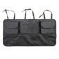 Black car trunk organizer bag with three front flap pockets and mesh panel, carry straps