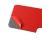 Carbon fiber-look sticker piece with red protective backing and curved cut edge