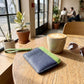 Square leather card holder with lanyard, blue front with green zipper edge