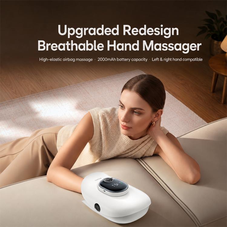 White hand massager positioned near a person’s hand on a couch