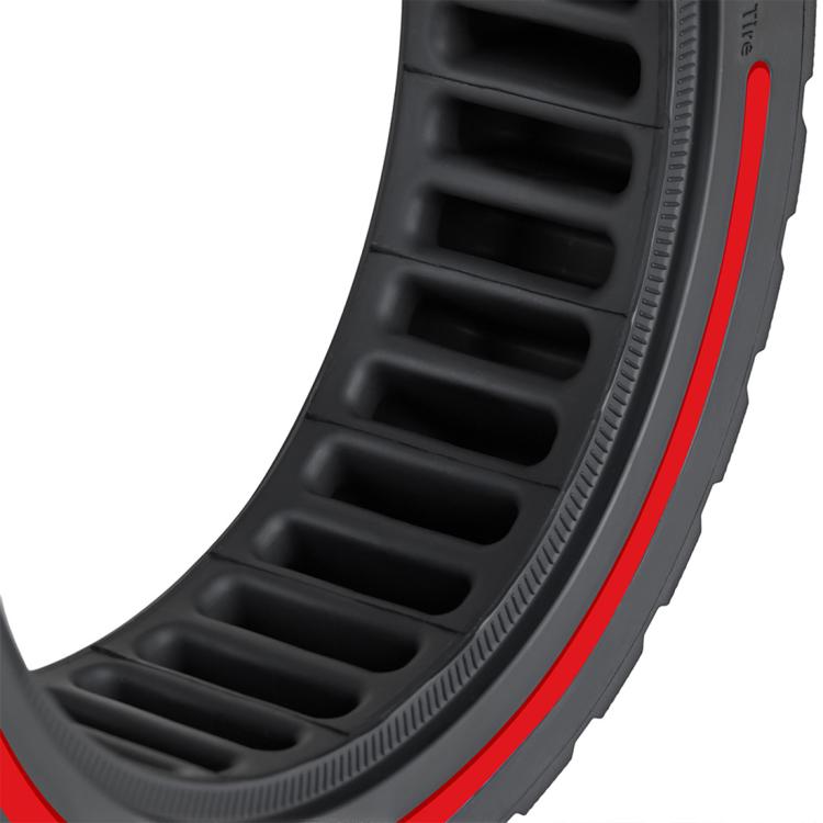 Close-up of black tire sidewall with red trim and molded vent channels