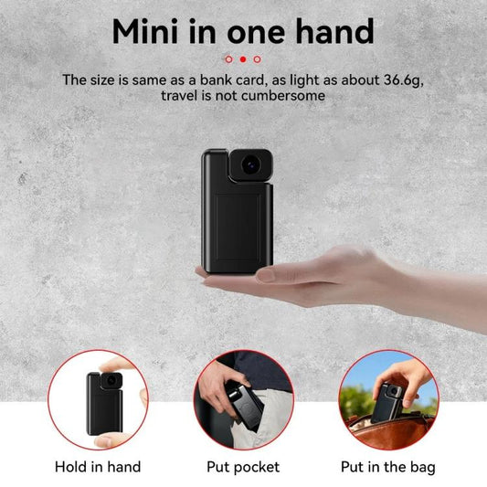 Black pocket-size mini camera held in a hand