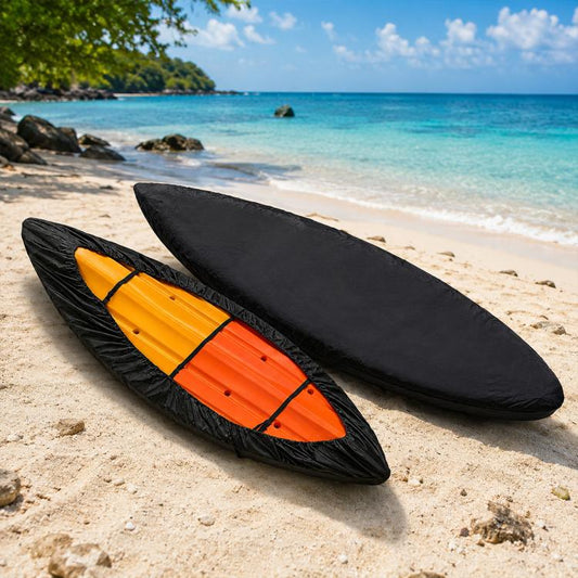 Two black kayak covers on sand, oval wraps with tie straps