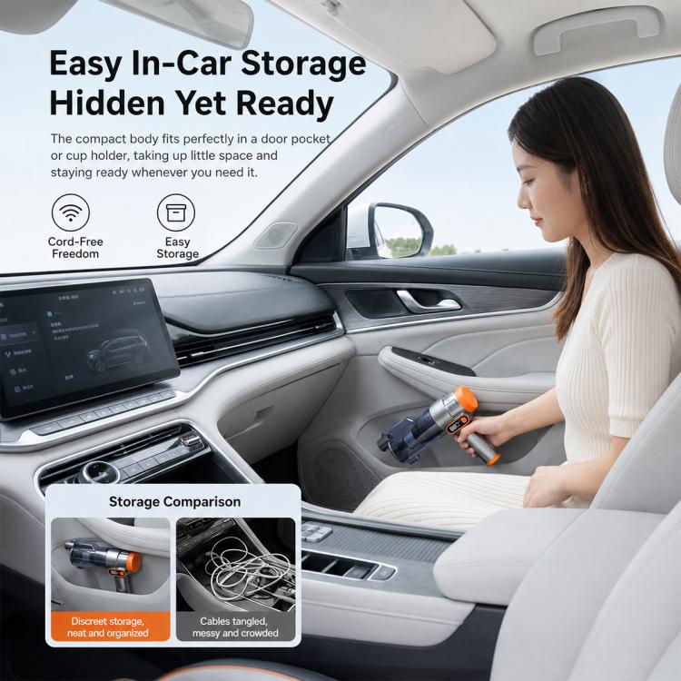 Handheld silver vacuum cleaner with orange accents, being used inside a car