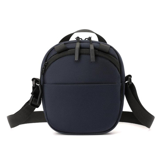Navy blue round nylon crossbody bag with adjustable shoulder strap and front zipper pocket
