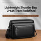 Black shoulder crossbody bag with front zipper, smooth top handle, and crossbody strap.