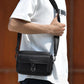 Black textured lychee crossbody bag with flap and adjustable shoulder strap