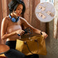 Woman using a gold handbag with a metal magnetic clasp closure on the strap