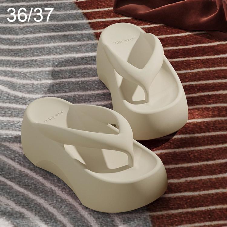 White EVA thick-soled flip-flops with wide crisscross strap and raised molded platform.