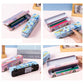Assorted views of pink and blue cartoon bus metal pencil cases with lids open and closed
