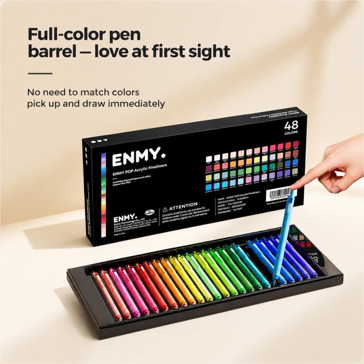 Acrylic fineliner colors box set open with multicolor pens and blue pen in hand