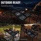 Portable folding metal dining table with perforated mosaic tabletop and four folding legs.