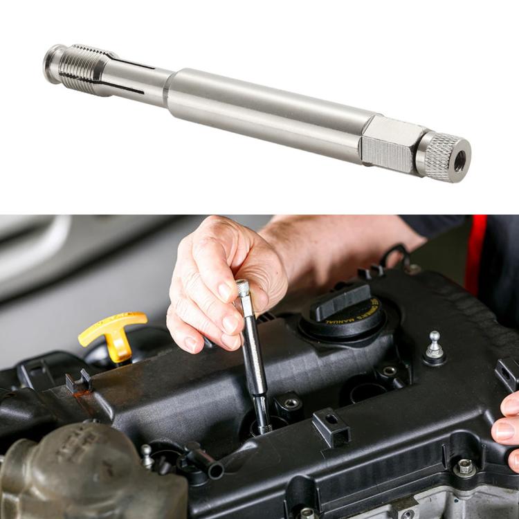 Spark plug thread repair tool with knurled handle and threaded end, held near engine