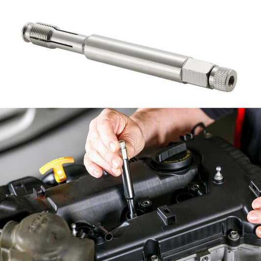 Spark plug thread repair tool with knurled handle and threaded end, held near engine