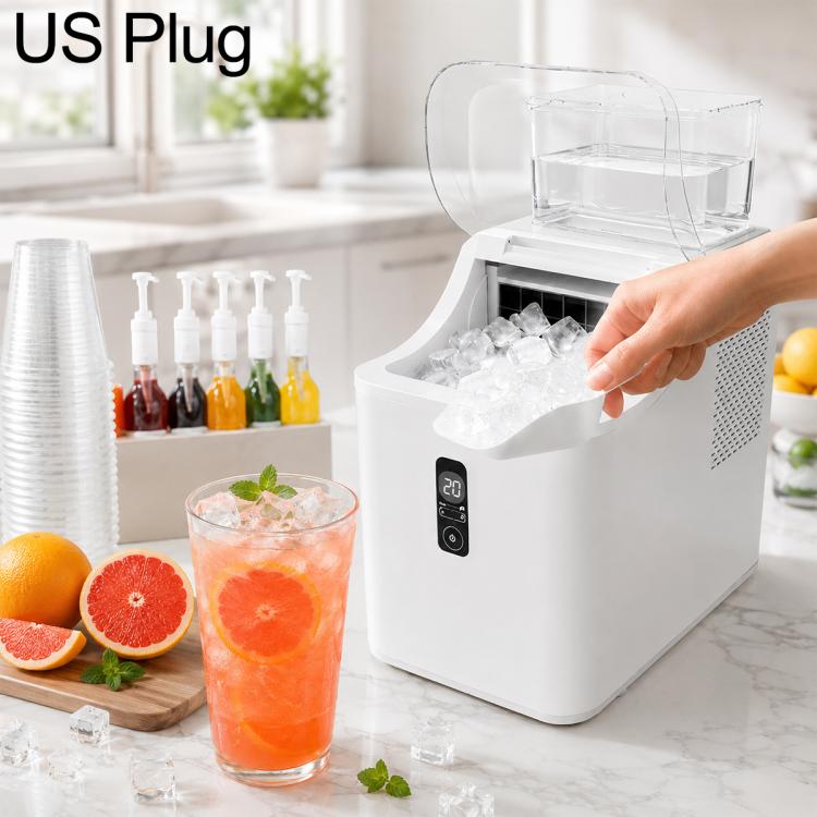 White cube ice maker with US plug, open ice bin and hand placing ice cubes