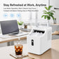 White countertop cube ice maker with open lid, ice cubes in bin and glass of iced drink