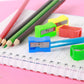 Manual single-hole pencil sharpeners with pencils and notebooks in view