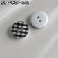 Colorful resin button set: black plaid and white buttons with black two-hole design.
