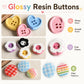 Glossy resin buttons with heart and flower shapes in pink, blue, yellow, and black