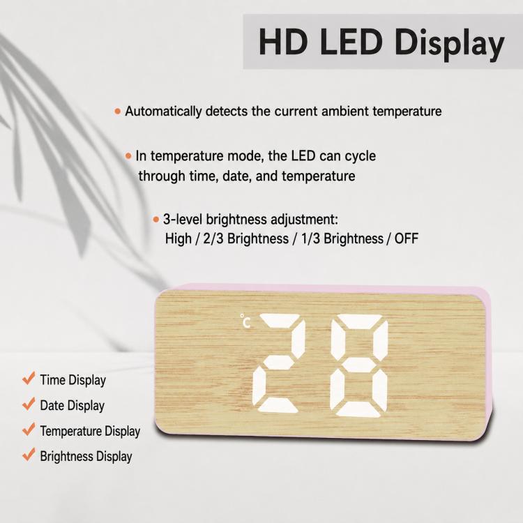 Pink bamboo-grain LED alarm clock showing 12-hour time and small temperature symbol.