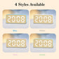 Four styles of bamboo-grain LED clock in blue, white, pink, and green color options.
