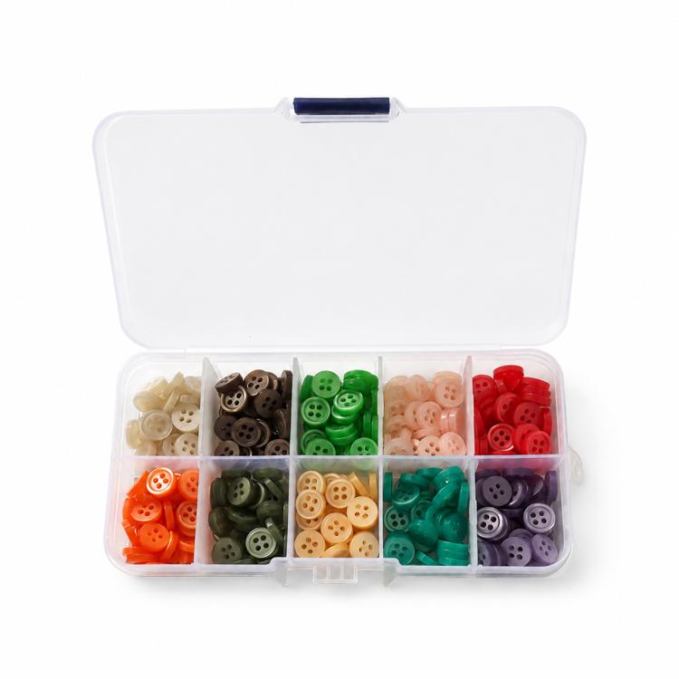 Mixed-color four-hole resin button kit in open organizer with divided compartments