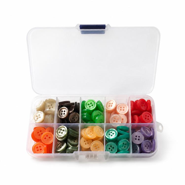Mixed-color four-hole resin buttons in open organizer, grouped by matching colors