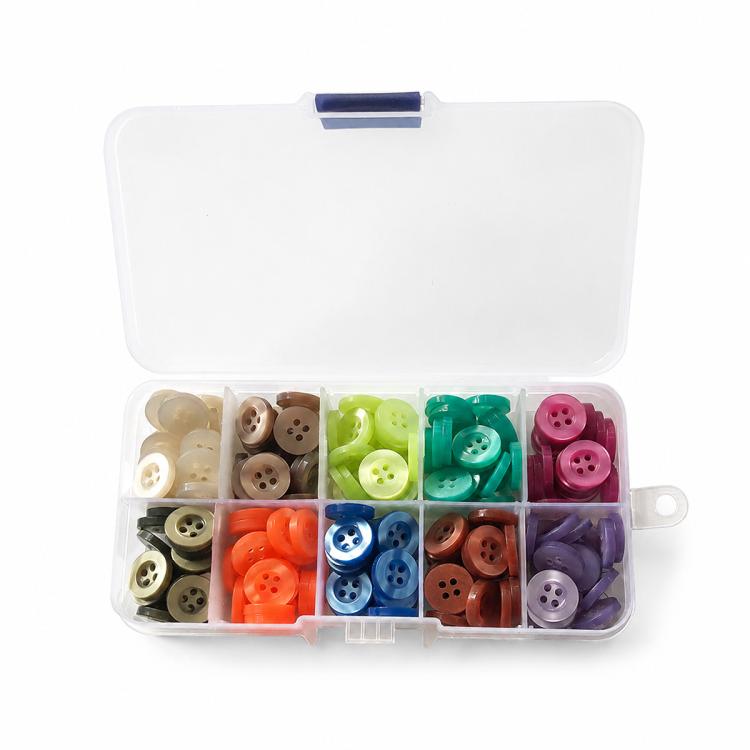 Mixed-color four-hole resin button kit in open organizer with pastel and dark tones