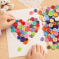Assorted four-hole resin buttons for crafts, with hands placing on paper