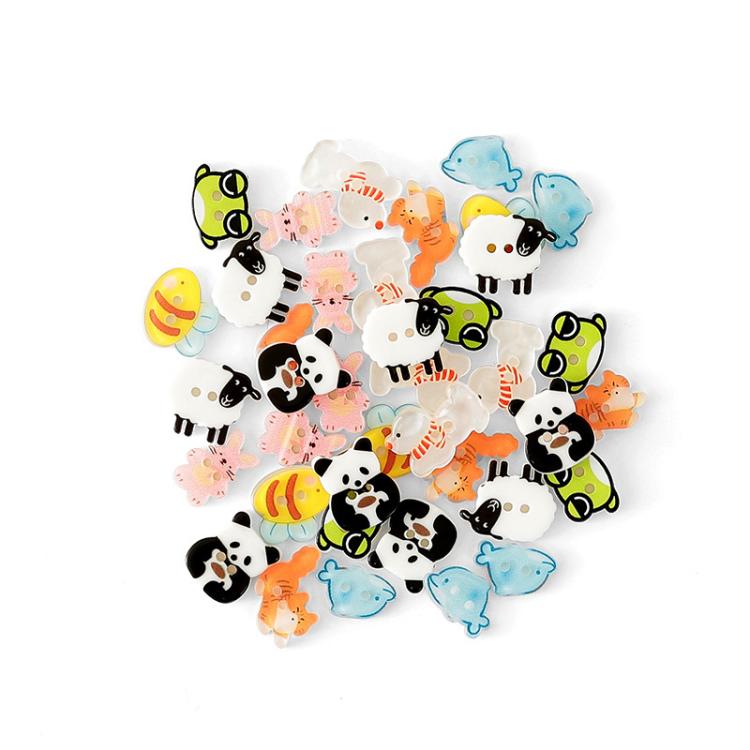 Assorted colorful animal-shaped resin buttons, scattered with panda, sheep, cat, frog, and bird shapes