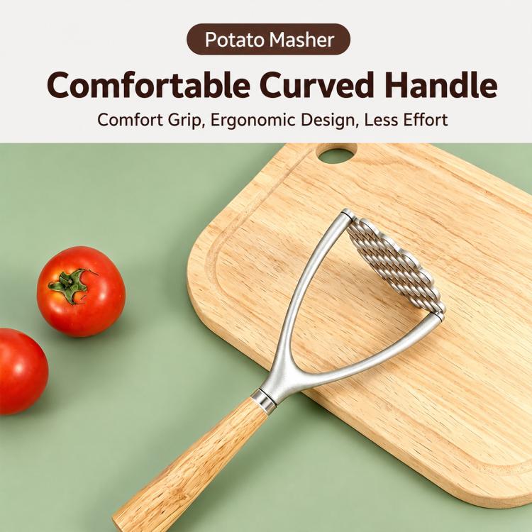 Potato masher with curved gray handle and oak grip lying across a wooden cutting board