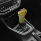 Palm-shaped manual gear shift knob with yellow-green resin finish and black stitched boot.