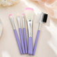 Lilac makeup brush set with five brushes, pink bristle tips, silver handles