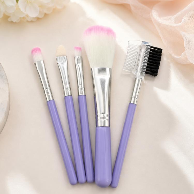 Lilac makeup brush set with five brushes, pink bristle tips, silver handles