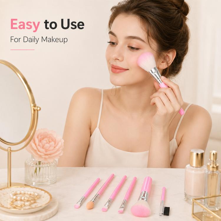 Pink makeup brush set with five brushes shown in use by a person