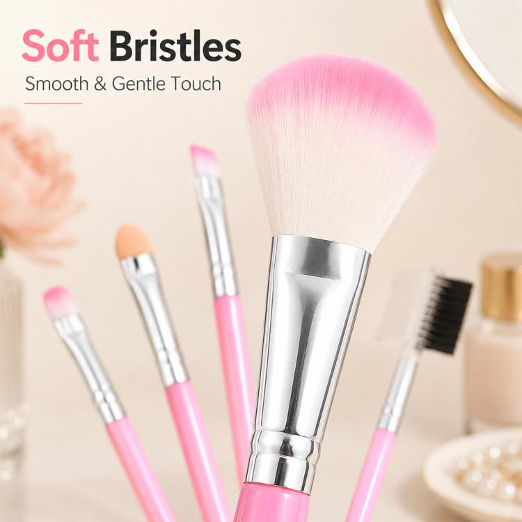 Pink makeup brush set close-up with large powder brush and four smaller brushes