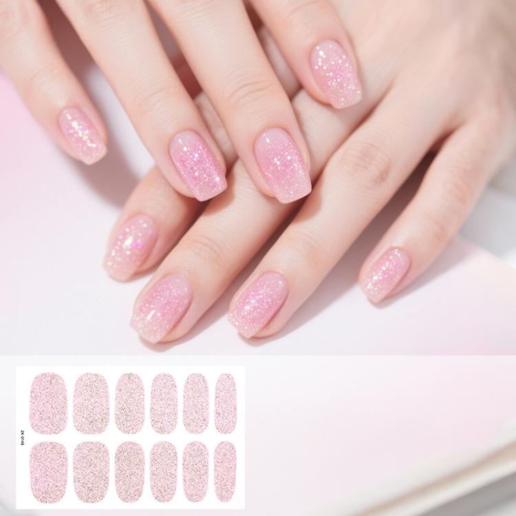 Pink glitter nail sticker sheet with oval full-coverage decals, worn on nails.