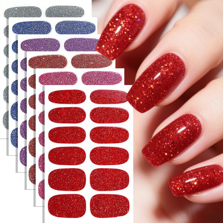 Red glitter nail sticker set with oval decals, shown on manicured fingernails.