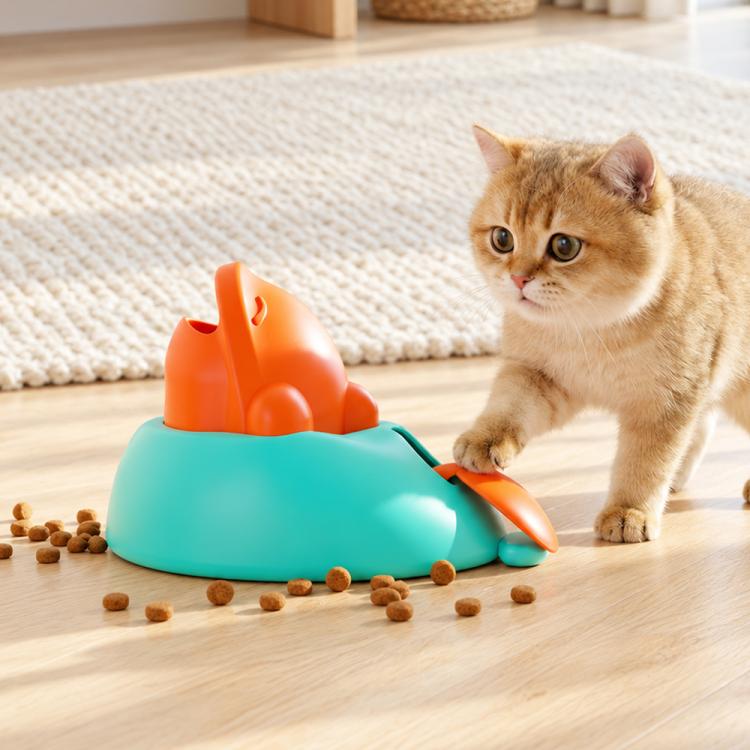 Interactive treat-launching whale-shaped pet toy, teal base with orange whale spout