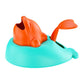 Whale-shaped treat-launch toy with orange top fins and teal launching dish