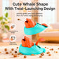 Two whale-shaped treat-launch toys on floor, teal base with orange whale