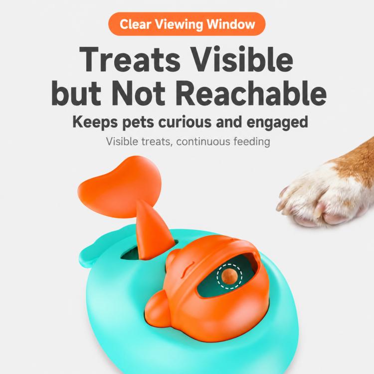 Whale-shaped treat-launch toy with orange opening and teal body, shown near paw
