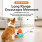 Whale-shaped treat-launch pet toy in teal with orange launcher, with dog nearby